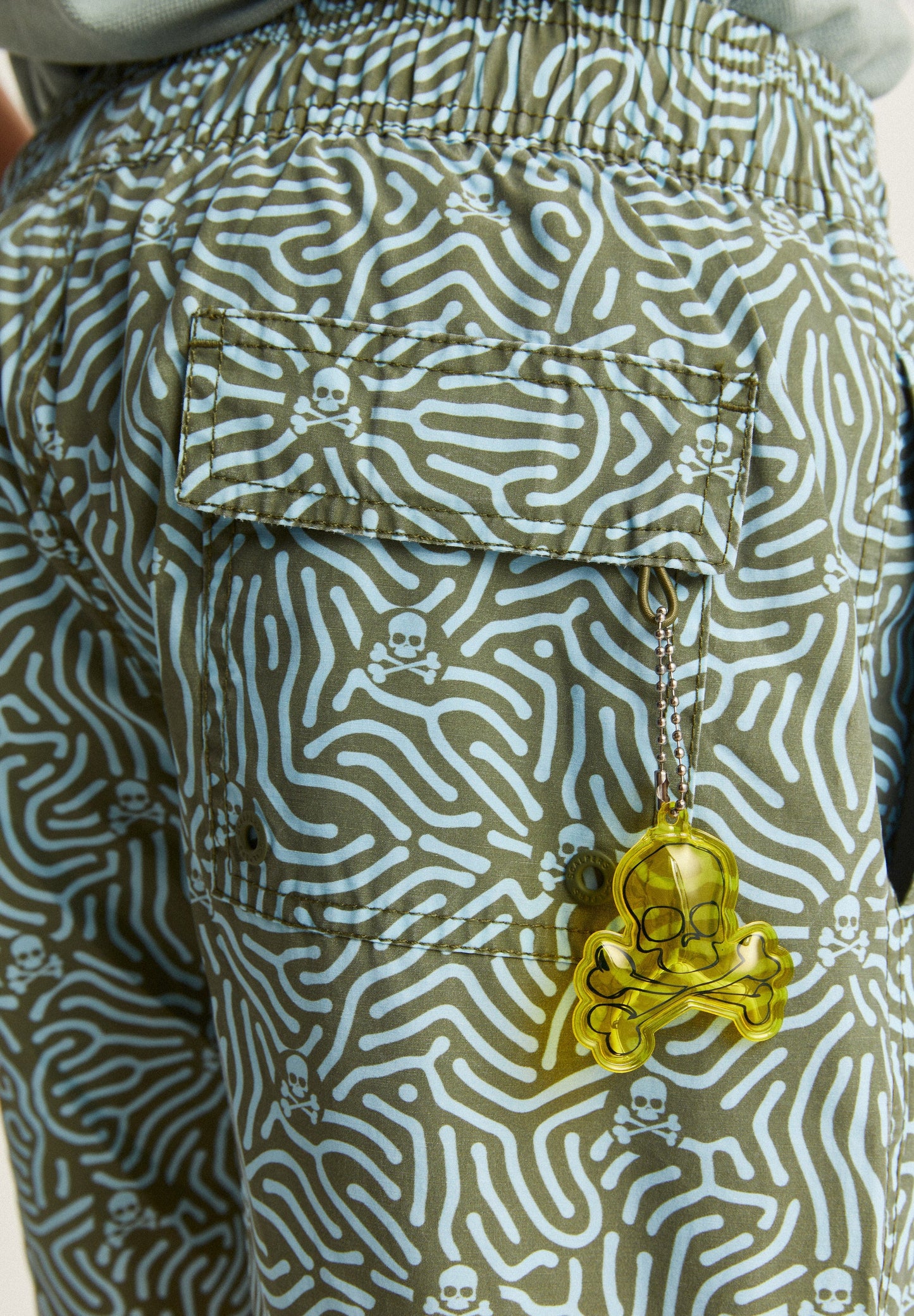 SWIMMING TRUNKS WITH ALL-OVER SKULLS DETAIL
